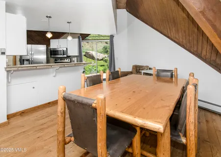 a kitchen with stainless steel appliances granite countertop wooden cabinets and wooden floor