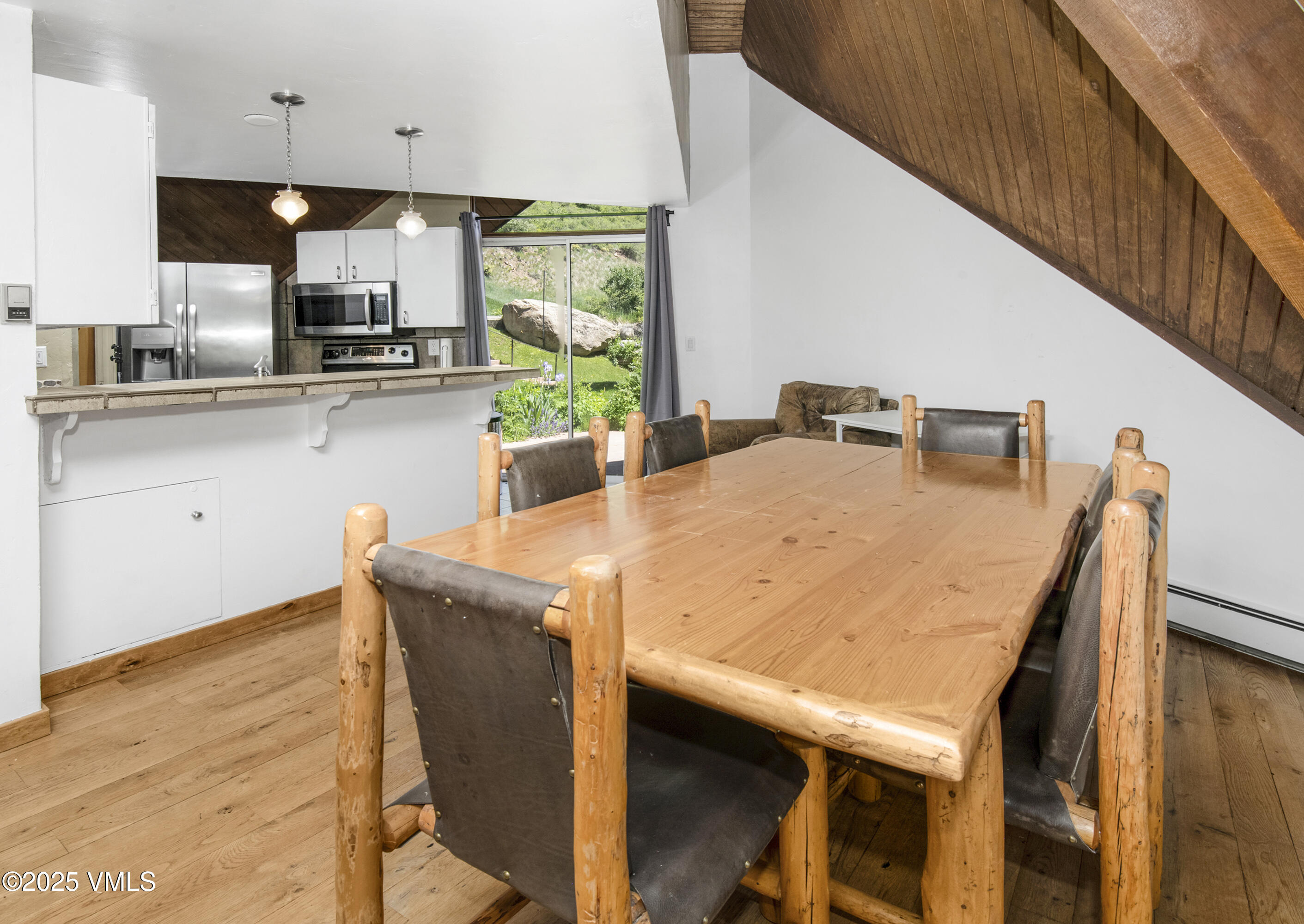 1400 Lions Ridge Loop, Unit A5 Vail, CO 81657 - Photo 10 of 32 a kitchen with stainless steel appliances granite countertop wooden cabinets and wooden floor