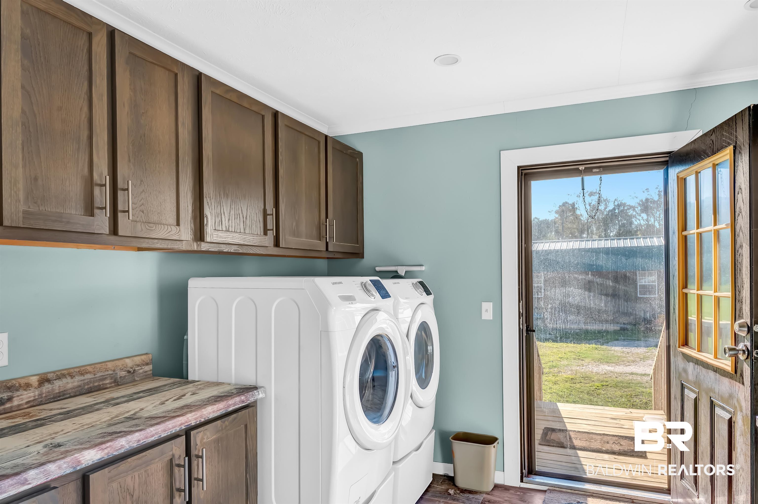 23233 Forland Road Silverhill, AL 36576 - Photo 16 of 33 Laundry area featuring a wealth of natural light, separate washer and dryer, and cabinet space