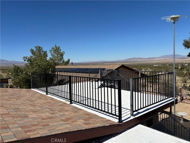 a view of empty room with wooden floor and windows