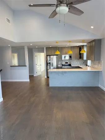 a view of a kitchen with a sink and cabinets