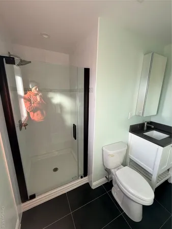 a bathroom with a toilet and a shower
