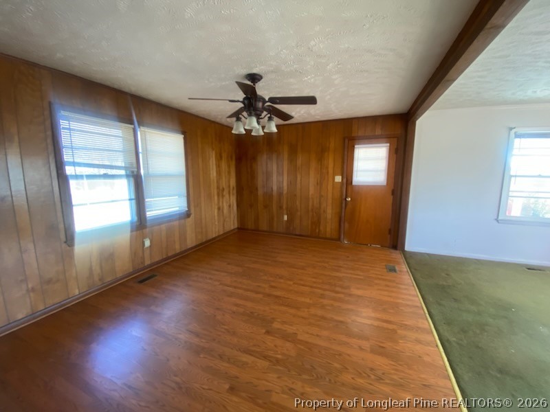2771 Bailey Road Fairmont, NC 28340 - Photo 3 of 10 an empty room with wooden floor and windows