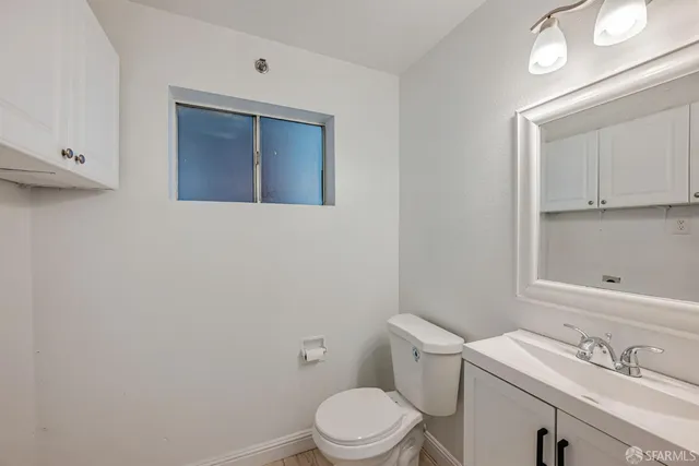 a white toilet sitting next to a bathroom sink