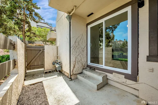 a view of an entryway with wooden floor and door
