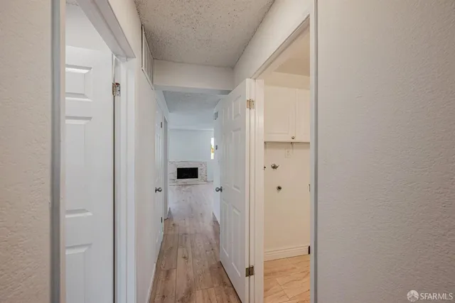 a view of a hallway with wooden floor