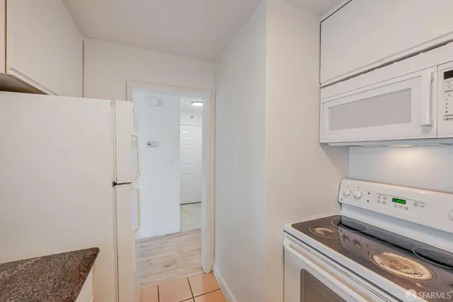 a kitchen with a refrigerator and cabinets