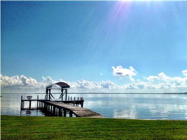 388 Shipwreck Road Santa Rosa Beach, FL 32459 - Photo 1 of 17 a view of a lake with a house in the background