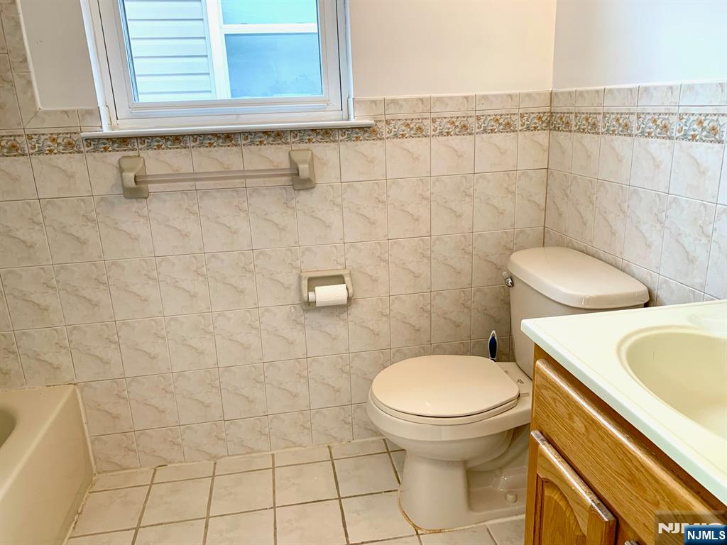 717 Jersey Street, Unit 2 Harrison, NJ 07029 - Photo 11 of 12 a bathroom with a toilet and a sink