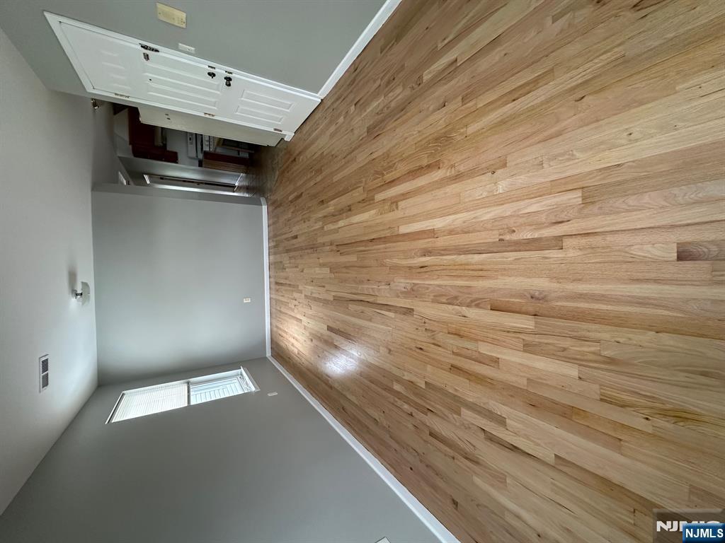 717 Jersey Street, Unit 2 Harrison, NJ 07029 - Photo 2 of 12 a view of empty room with wooden floor