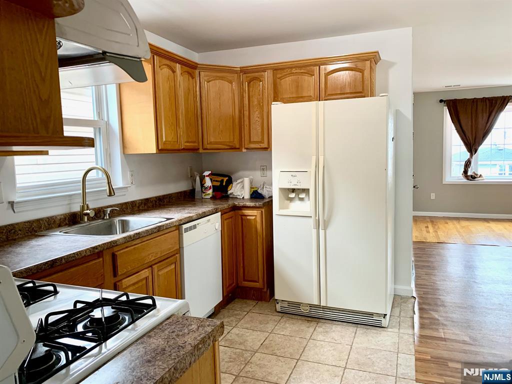 717 Jersey Street, Unit 2 Harrison, NJ 07029 - Photo 4 of 12 a kitchen with a sink a refrigerator and cabinets
