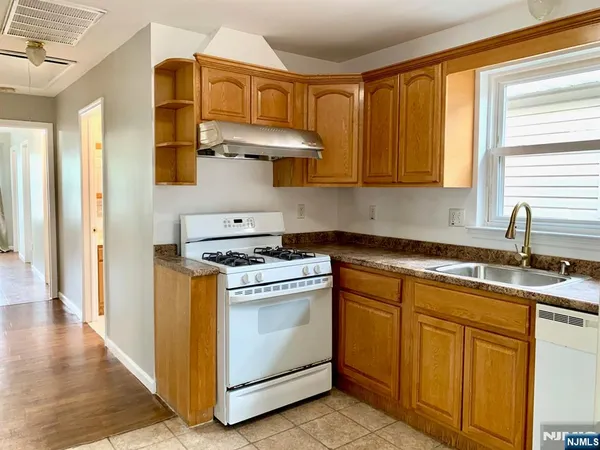 a kitchen with cabinets appliances and a window