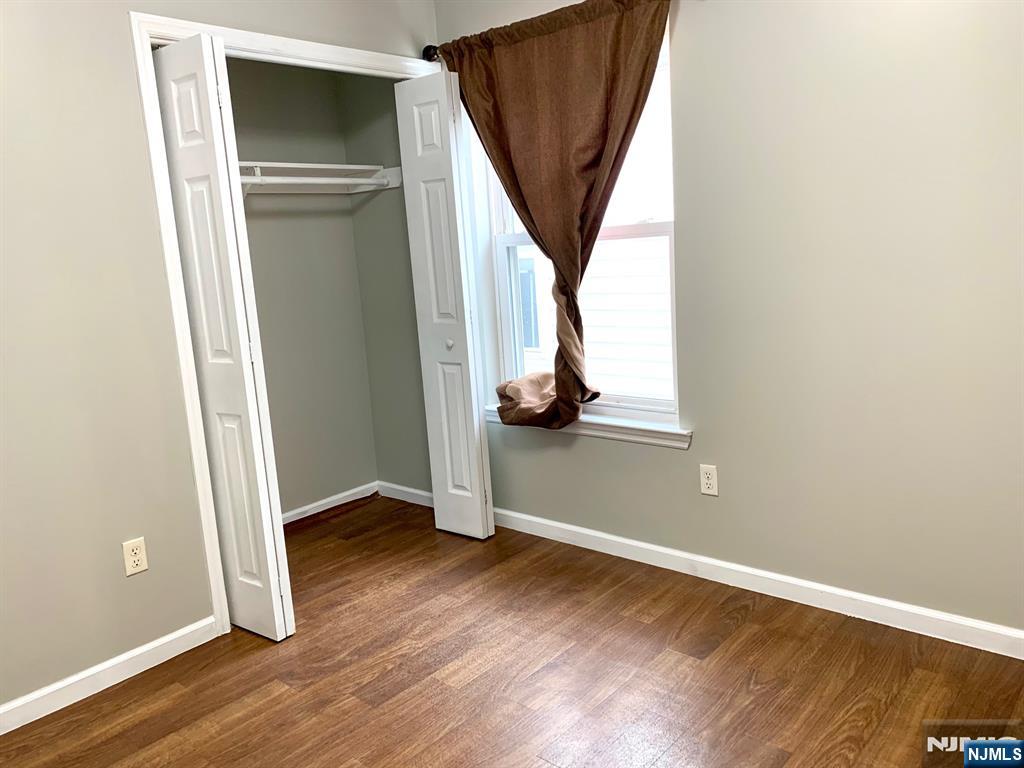717 Jersey Street, Unit 2 Harrison, NJ 07029 - Photo 7 of 12 an entryway with wooden floor and stairs