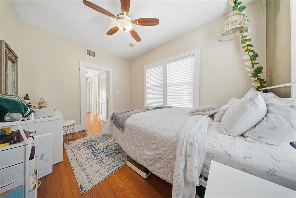8334 Diagonal Road North St. Petersburg, FL 33702 - Photo 19 of 57 a bedroom with a bed chandelier and a window