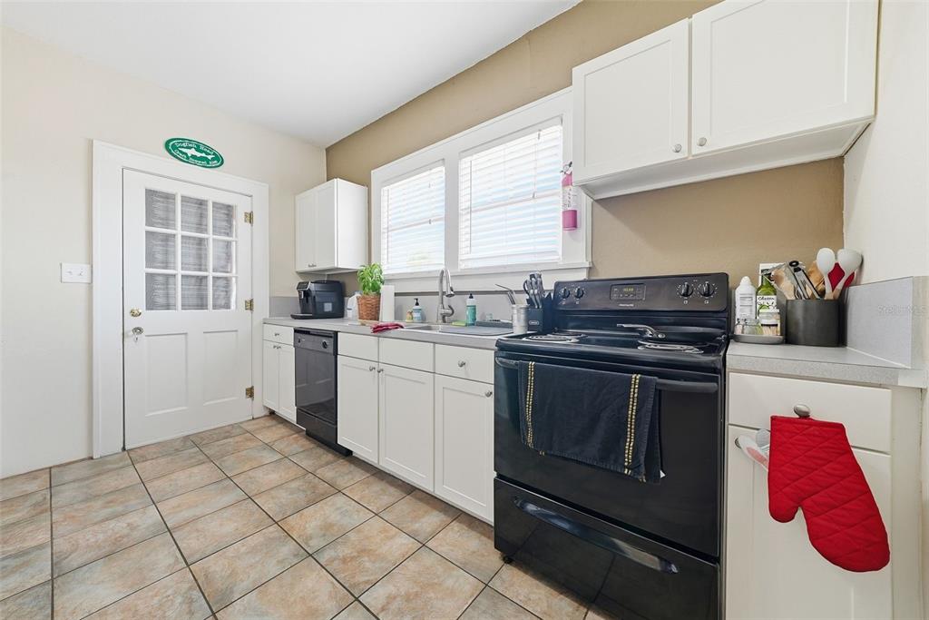 8334 Diagonal Road North St. Petersburg, FL 33702 - Photo 28 of 57 a kitchen with a sink stove and cabinets