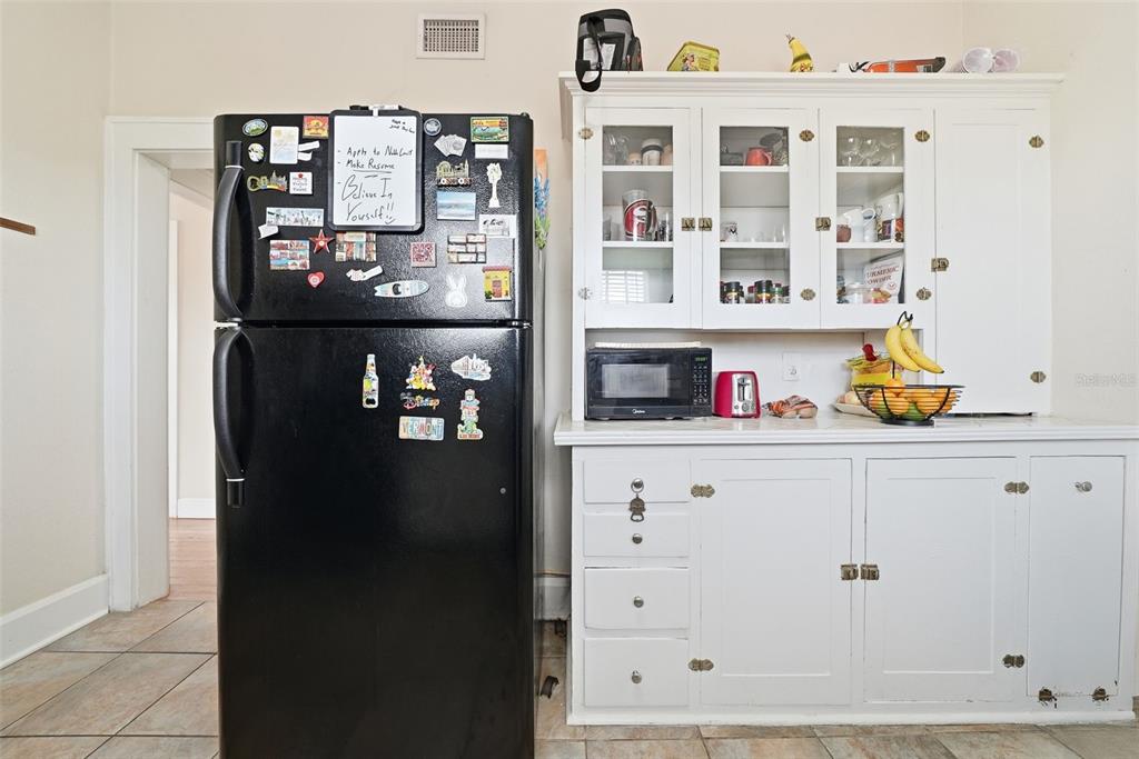 8334 Diagonal Road North St. Petersburg, FL 33702 - Photo 29 of 57 a kitchen with a refrigerator and cabinets