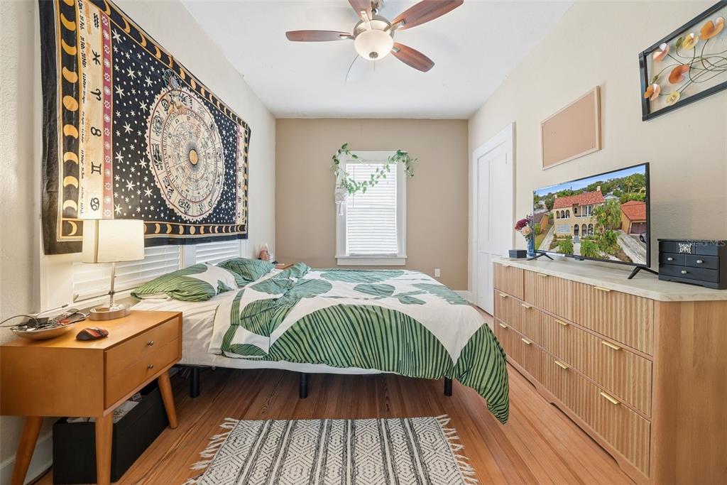 8334 Diagonal Road North St. Petersburg, FL 33702 - Photo 30 of 57 a bedroom with a bed and a flat tv screen on dresser