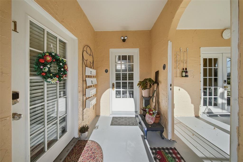 8334 Diagonal Road North St. Petersburg, FL 33702 - Photo 4 of 57 a hallway with a chandelier and wooden floor