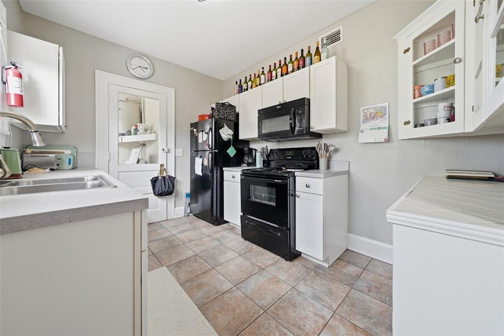 8334 Diagonal Road North St. Petersburg, FL 33702 - Photo 8 of 57 a kitchen with stainless steel appliances a stove a sink and a refrigerator