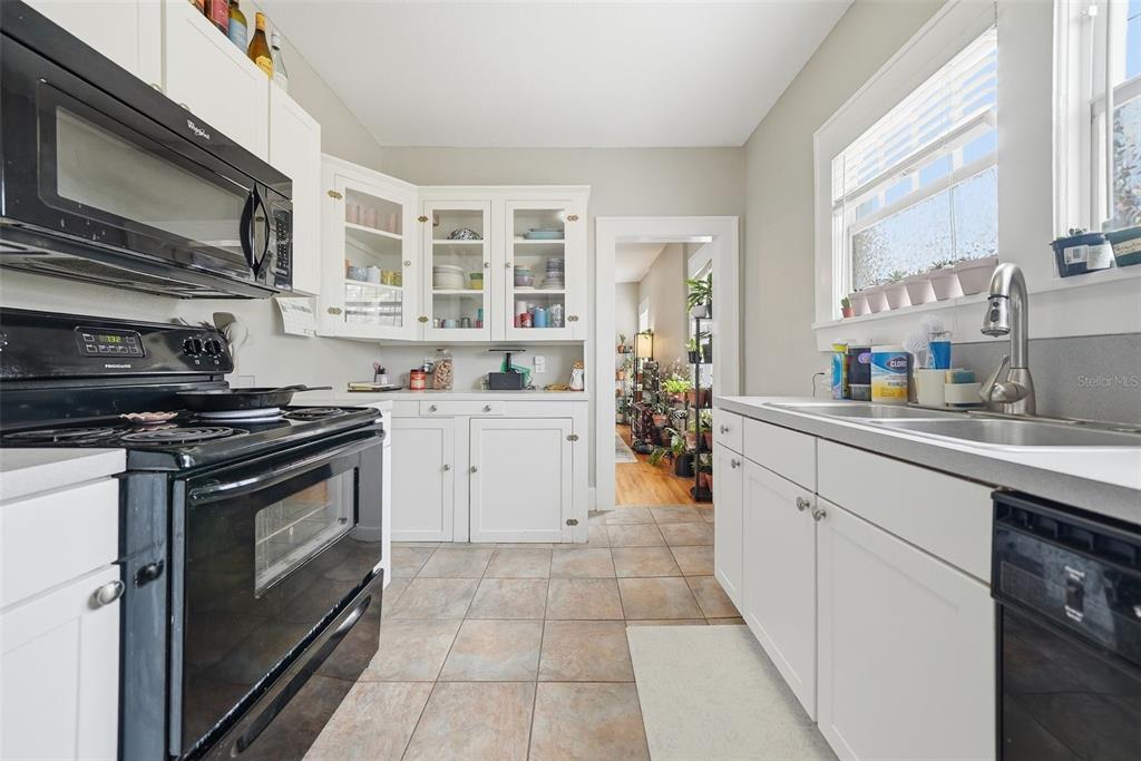 8334 Diagonal Road North St. Petersburg, FL 33702 - Photo 9 of 57 a kitchen with stainless steel appliances a stove sink and cabinets
