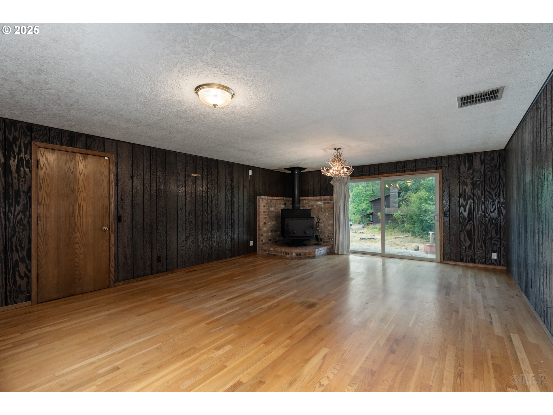 30004 Scappoose Vernonia Highway Scappoose, OR 97056 - Photo 7 of 33 a view of empty room with wooden floor and fan
