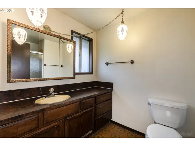 a bathroom with a sink a mirror and a toilet