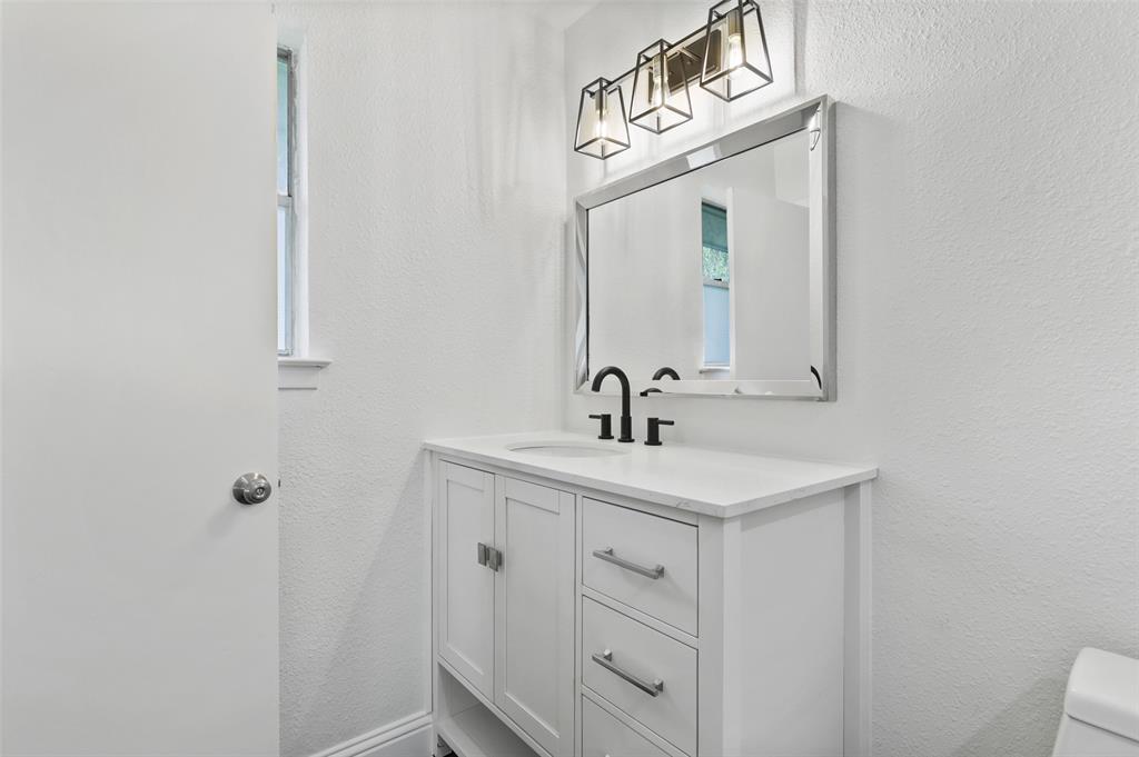 3126 Jubilee Trail Dallas, TX 75229 - Photo 19 of 38 a bathroom with a sink a light fixture and a mirror