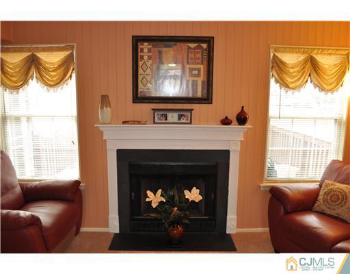 151 Skipton Place Somerset, NJ 08873 - Photo 7 of 10 a living room with chairs a fireplace and a large window