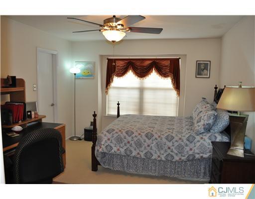 151 Skipton Place Somerset, NJ 08873 - Photo 8 of 10 a living room with a bed furniture and a window
