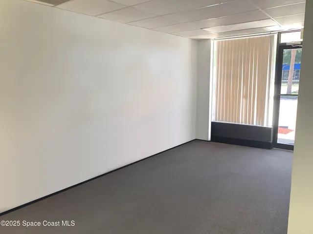 a view of an empty room and a window