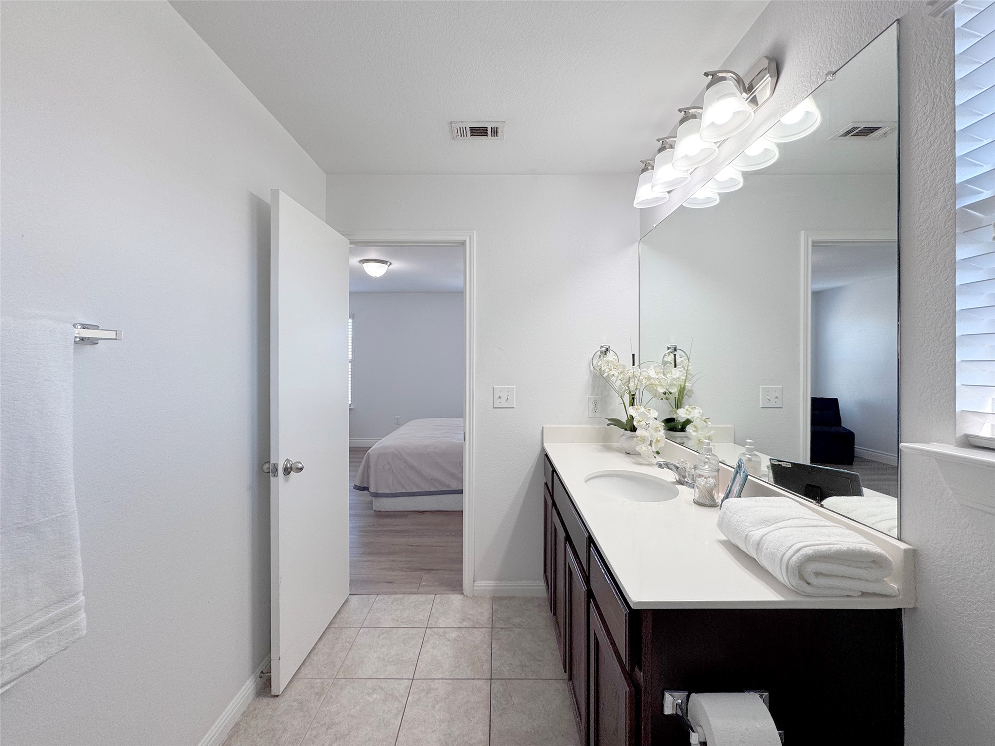 251 Triumph Road Buda, TX 78610 - Photo 20 of 26 Bathroom with vanity, ensuite bathroom, and light tile patterned flooring