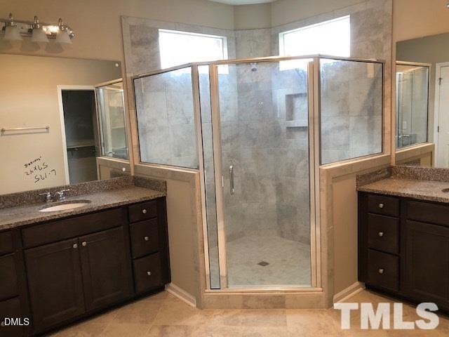 1600 Silo Ridge Drive Wake Forest, NC 27587 - Photo 13 of 16 a bathroom with a granite countertop shower sink and mirror