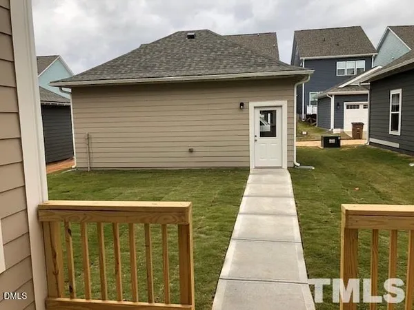 an aerial view of a house with outdoor space and a lake view
