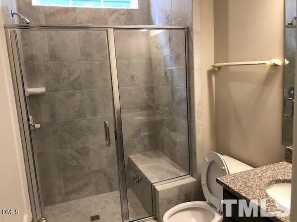 a bathroom with a shower and toilet