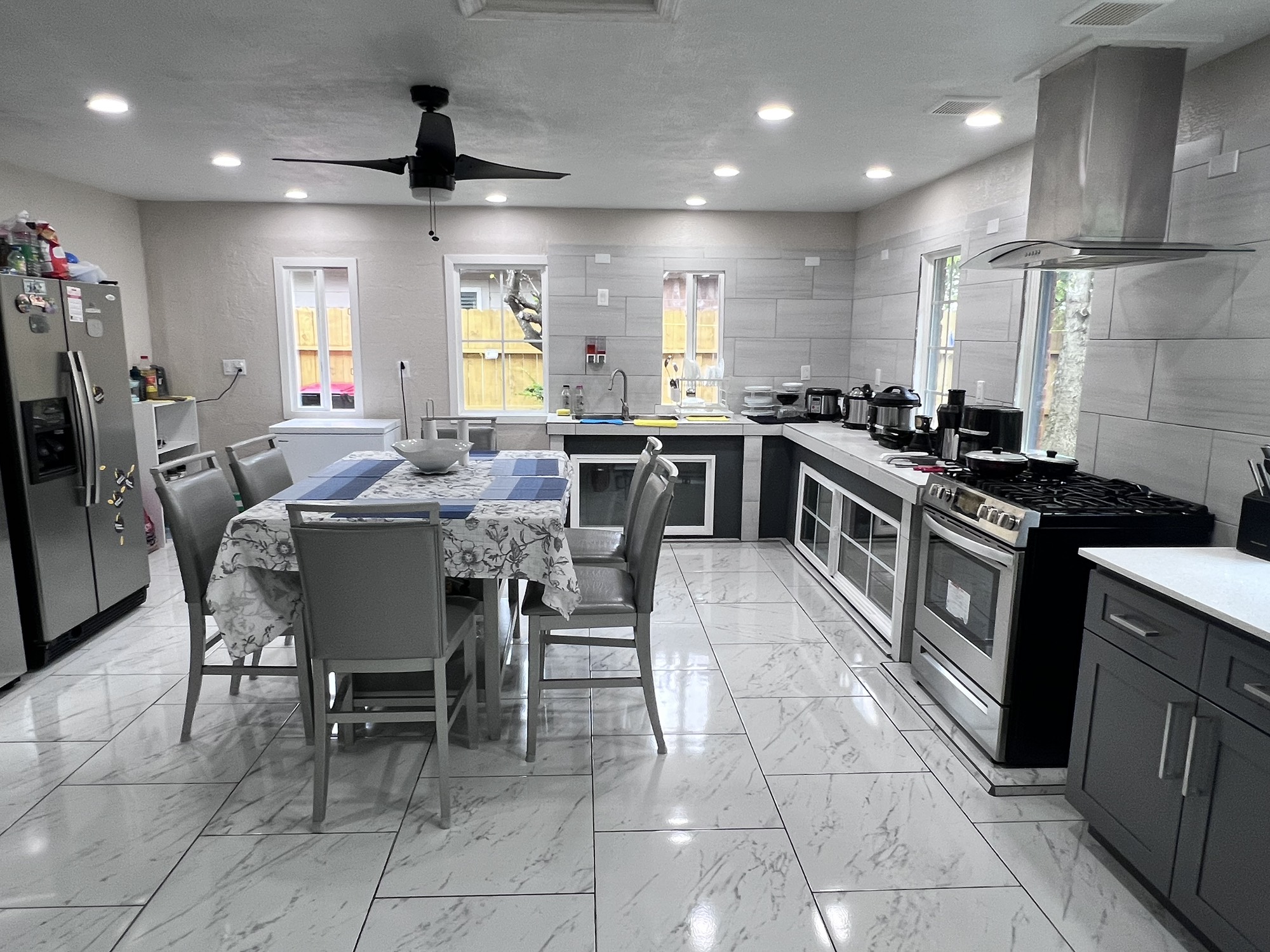 10807 Spring Harvest Drive Houston, TX 77064 - Photo 5 of 12 a kitchen with stainless steel appliances granite countertop a table chairs sink and cabinets