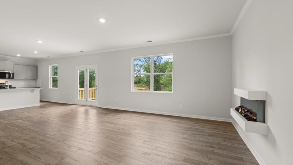 174 Thompson Ridge Lane Dallas, GA 30132 - Photo 15 of 35 a view of an empty room with wooden floor and a window