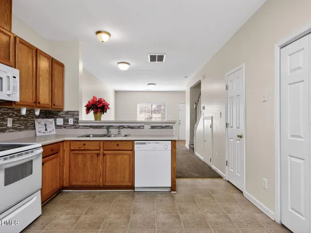 a kitchen with stainless steel appliances granite countertop a sink and cabinets