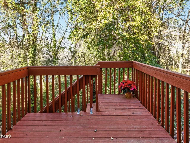 a view of empty room with wooden floor and windows