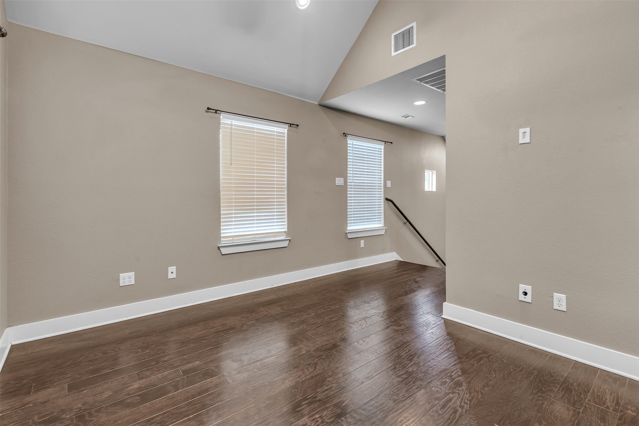12212 Tawny Farms Road, Unit 142 Austin, TX 78748 - Photo 14 of 21 Rich hardwood floors complement the natural light streaming through blinds, highlighting the inviting living space.