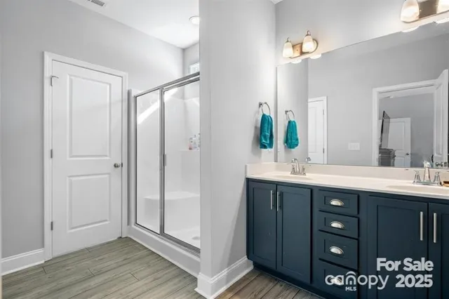 a bathroom with a double vanity sink and mirror