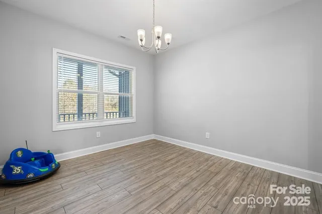 a room with wooden floor and window