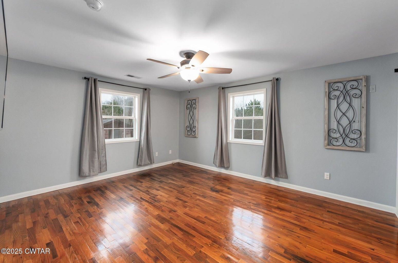 2510 Norton Road Middleton, TN 38052 - Photo 12 of 20 Empty room featuring plenty of natural light, dark wood-type flooring, and ceiling fan