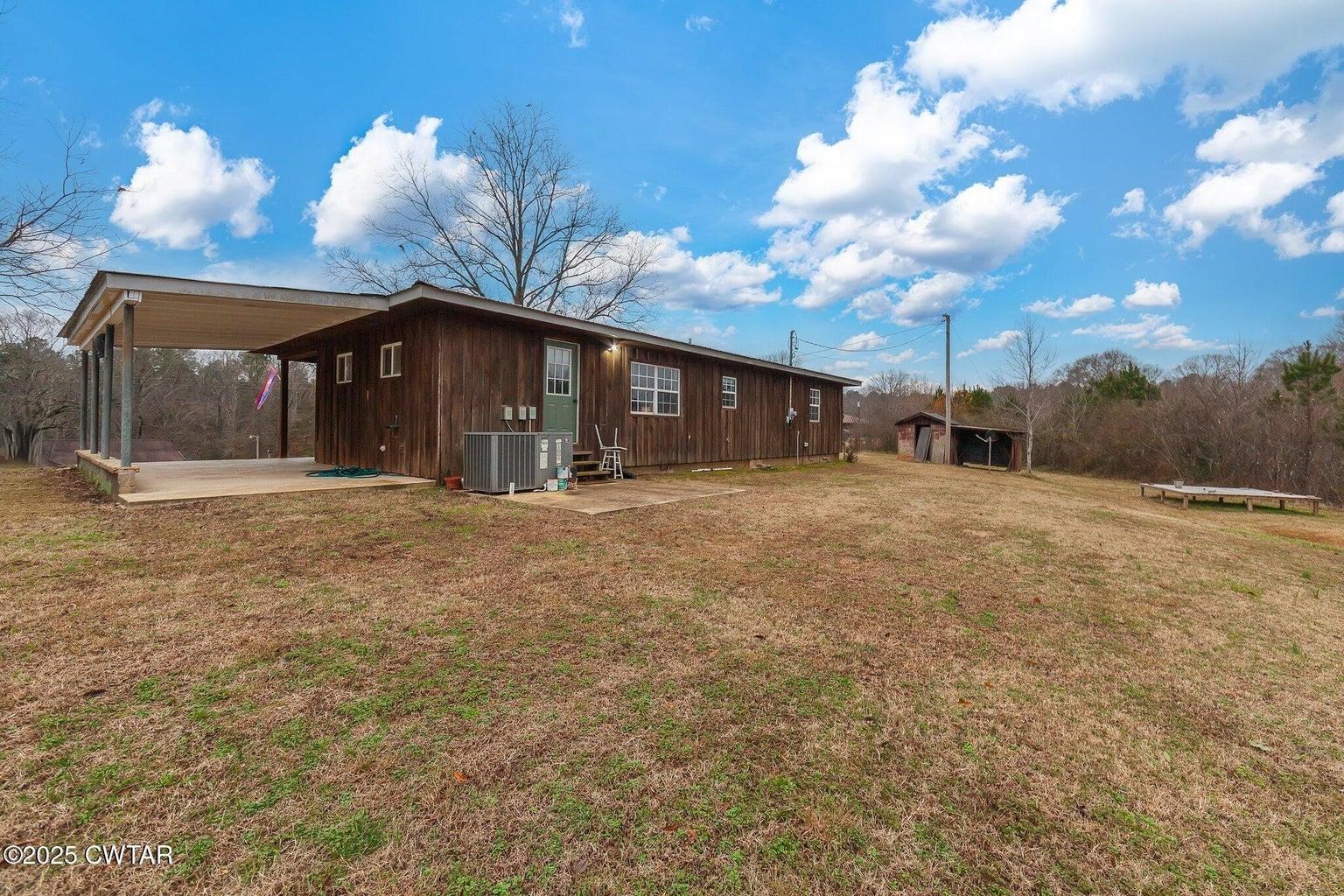 2510 Norton Road Middleton, TN 38052 - Photo 19 of 20 View of home's exterior featuring a patio area, a yard, and central AC unit