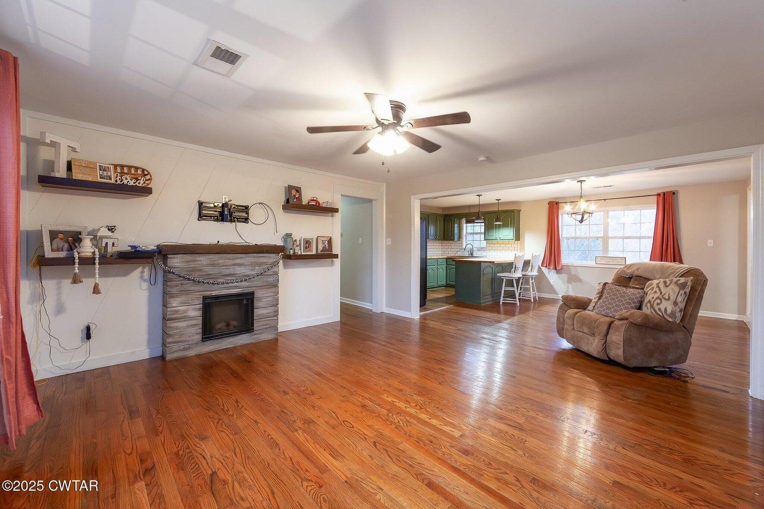2510 Norton Road Middleton, TN 38052 - Photo 3 of 20 Living room with sink, ceiling fan with notable chandelier, and hardwood / wood-style flooring