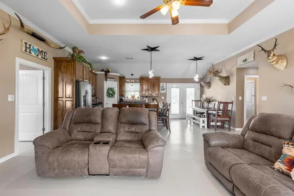 a living room with furniture and a chandelier