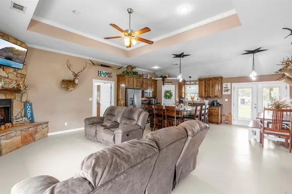 a living room with furniture a chandelier and a chandelier