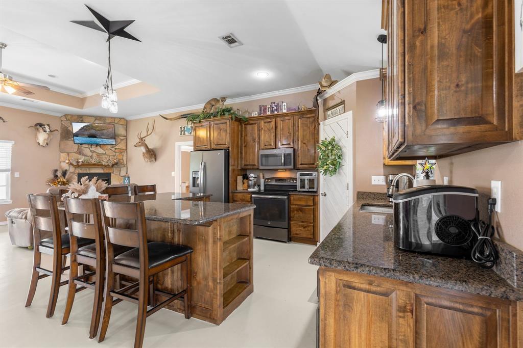 660 Milton-Minter Road Deport, TX 75435 - Photo 14 of 40 a kitchen with kitchen island counter top space cabinets and stainless steel appliances