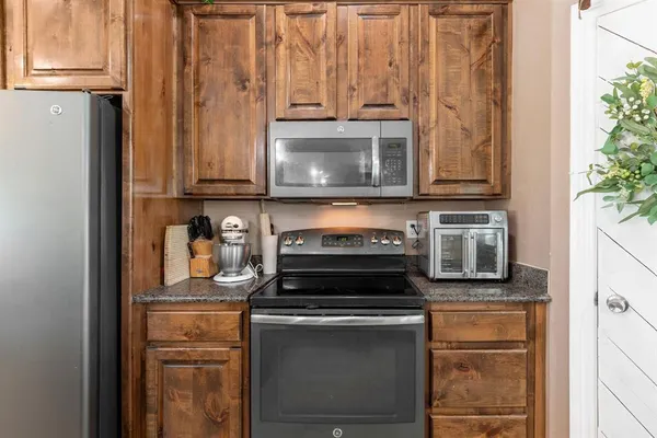 a stove top oven sitting inside of a kitchen
