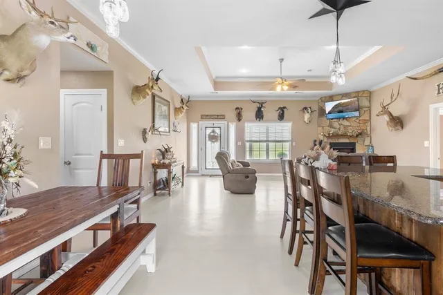 a view of a dining room with furniture and a chandelier