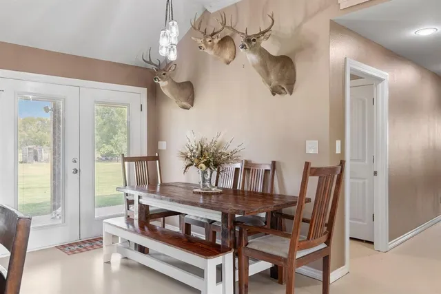 a dining room with furniture and window